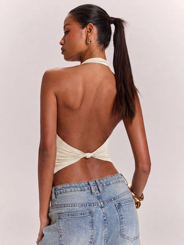 Women's knitted halter tank top with backless twisted knot design and asymmetrical hem