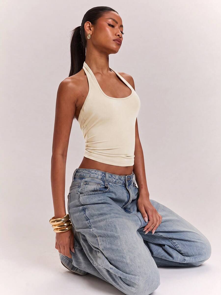 Women's knitted halter tank top with backless twisted knot design and asymmetrical hem