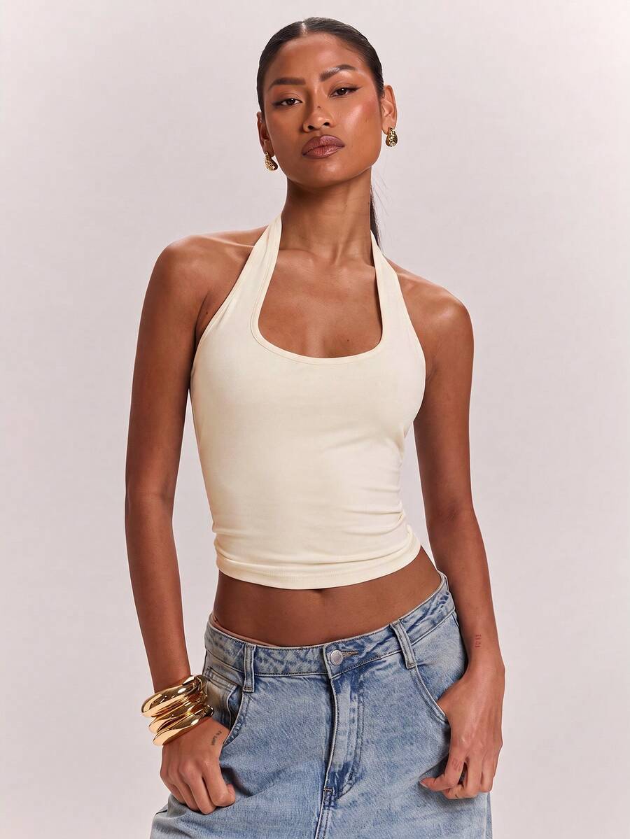 Women's knitted halter tank top with backless twisted knot design and asymmetrical hem