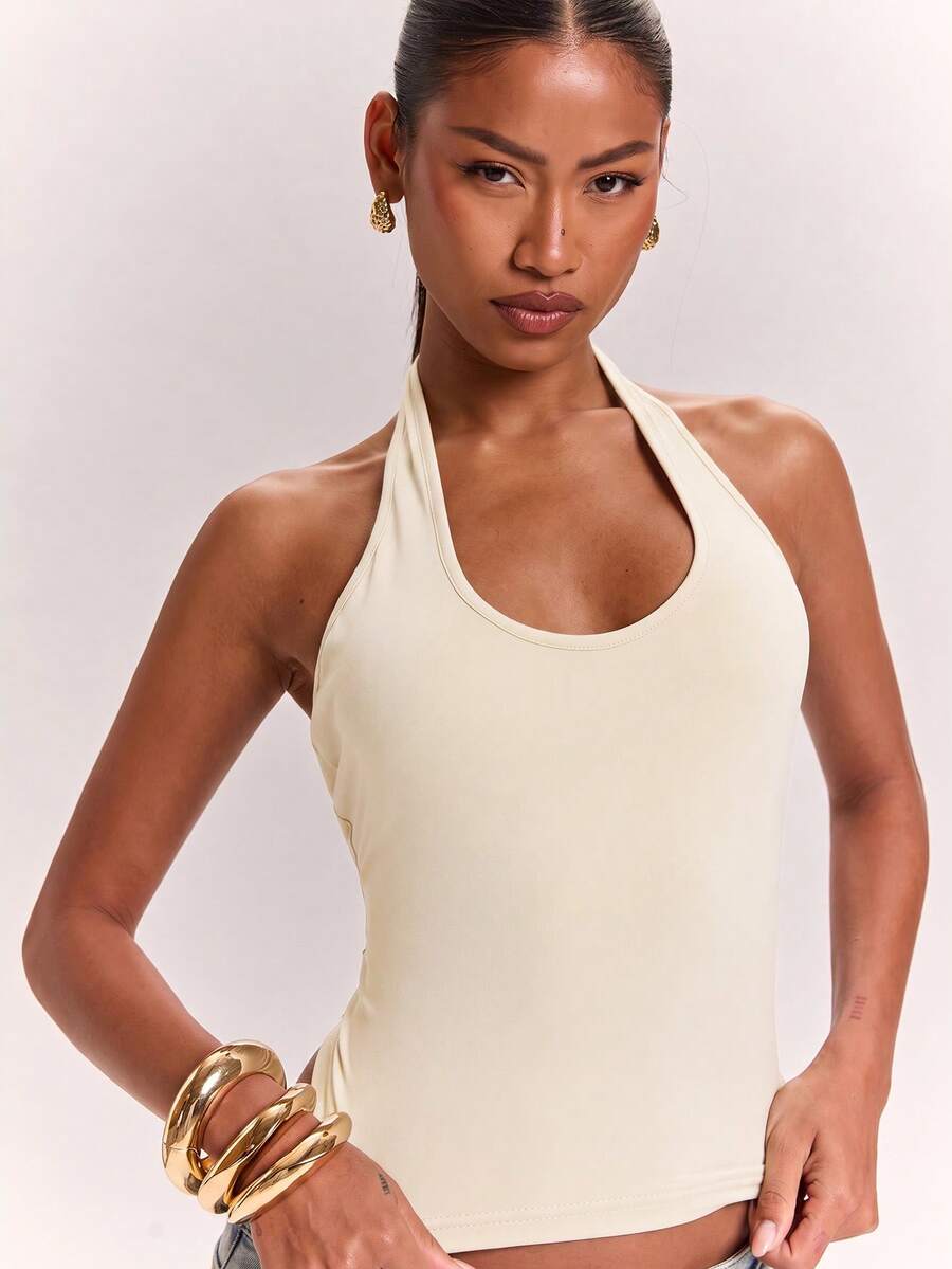 Women's knitted halter tank top with backless twisted knot design and asymmetrical hem