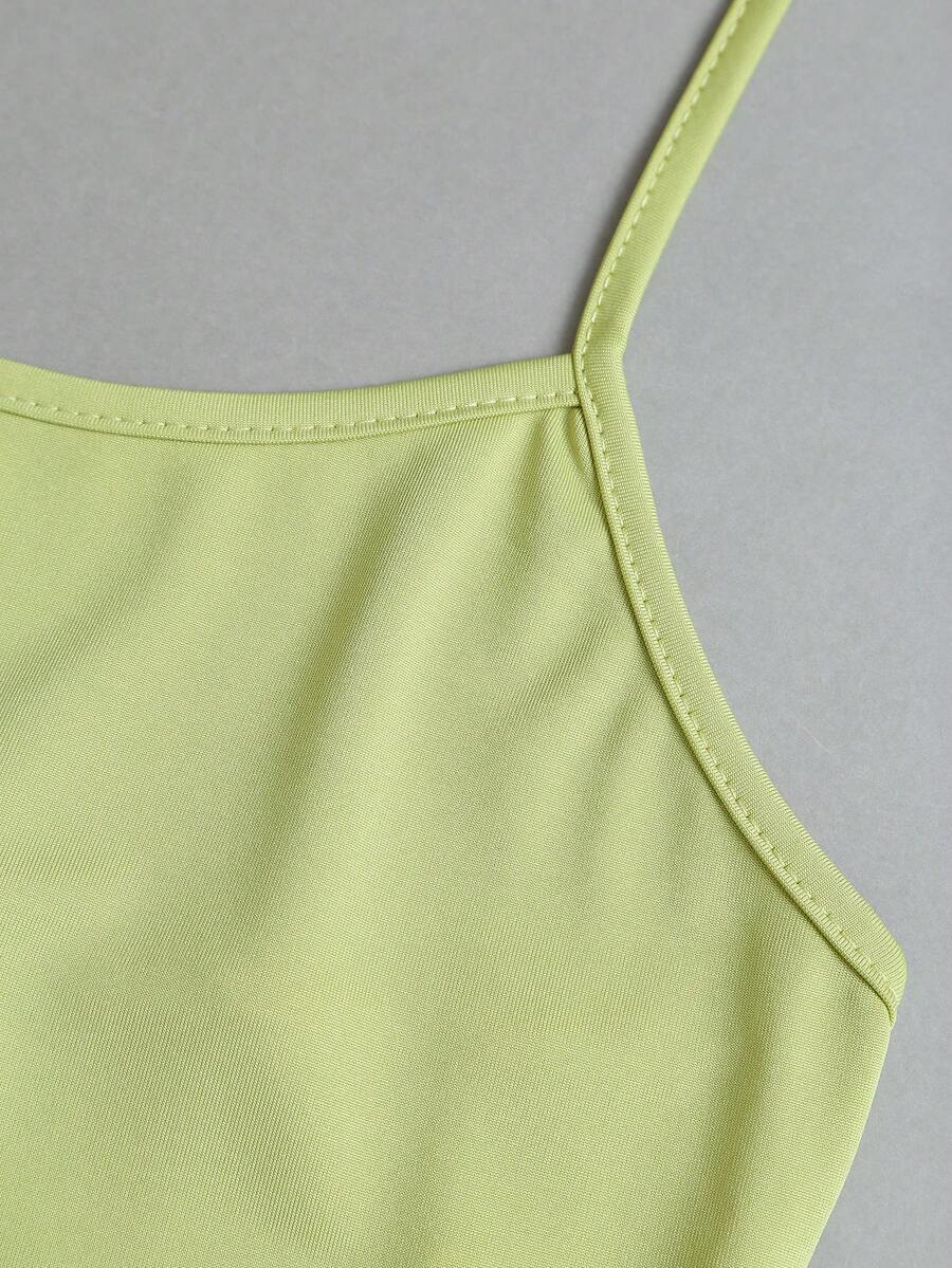 Women's striped tank top featuring an asymmetrical cold shoulder neckline and semi-sheer back.