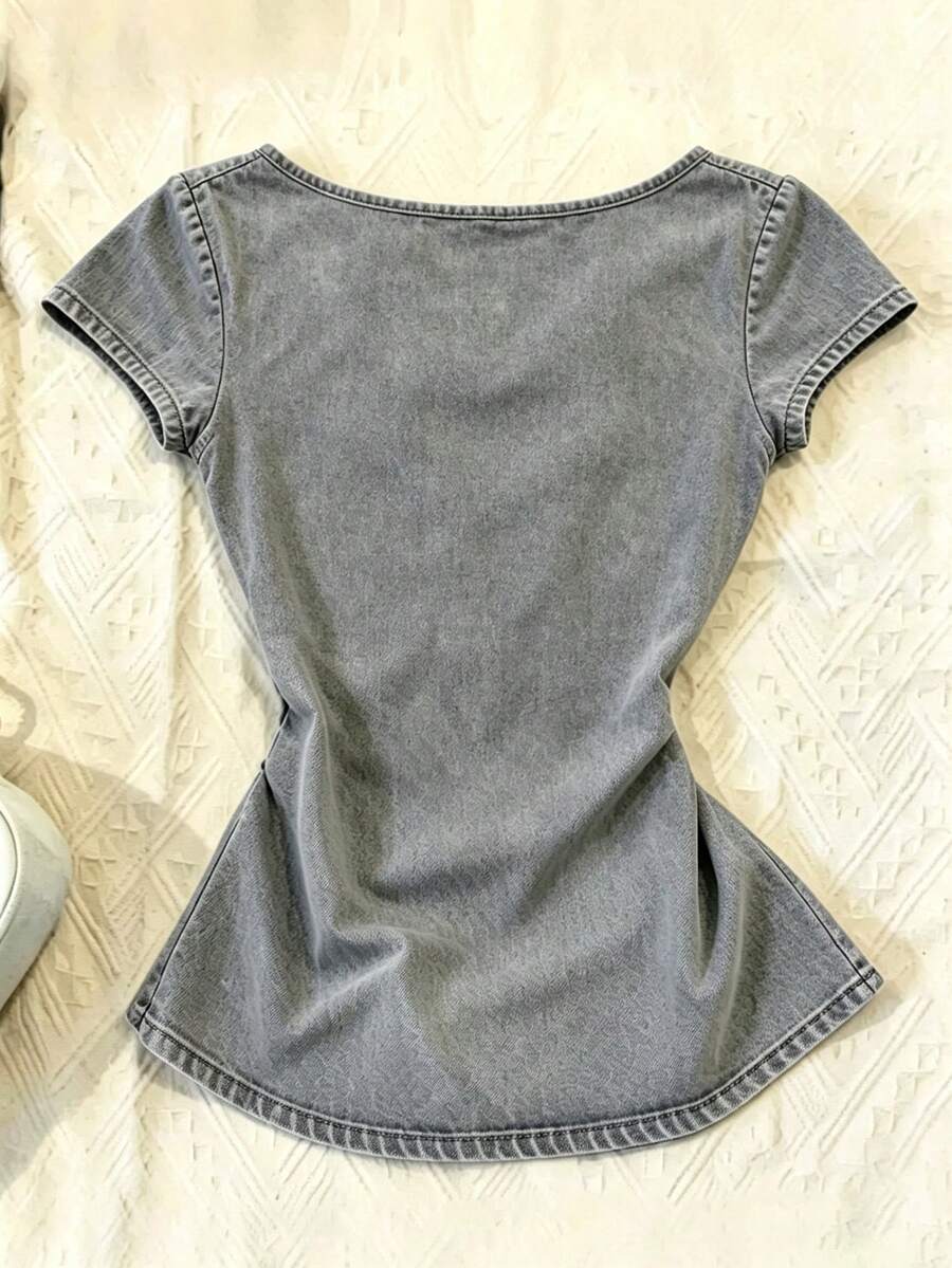 Women's polka dot short sleeve raglan t-shirt with a twist front detail and contrast collar.