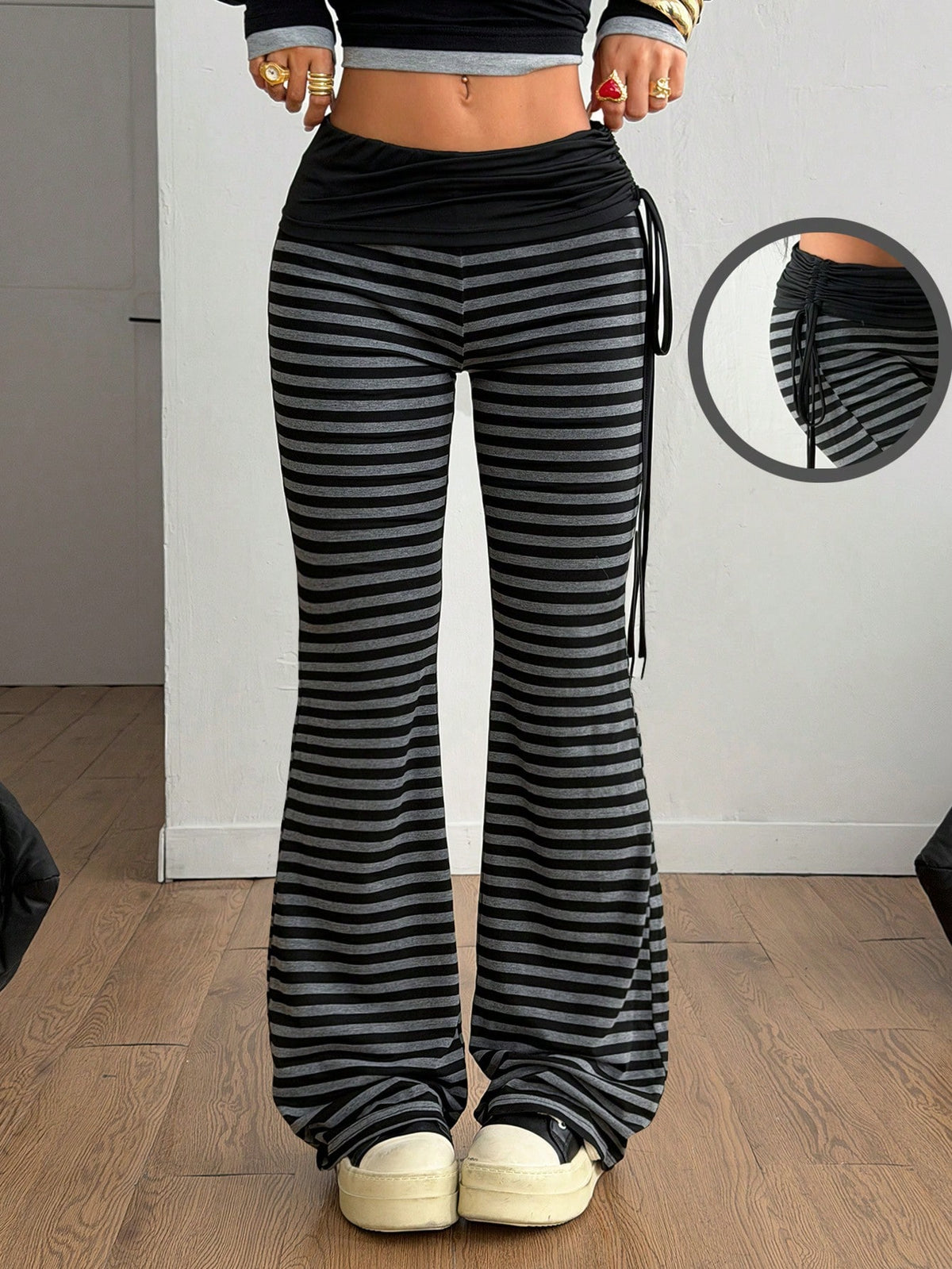 Women's black and white polka dot flare leg pants with side drawstring and ruched details