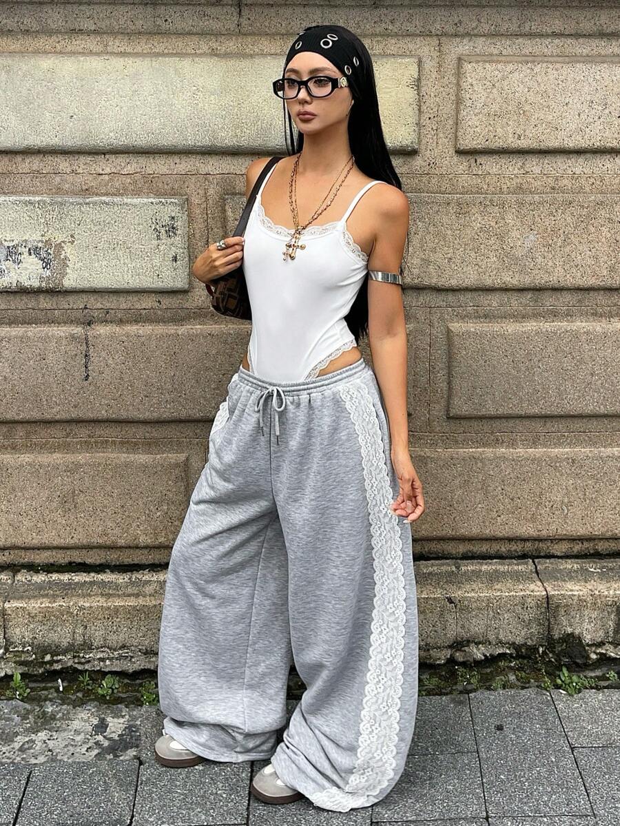 Women's wide leg trousers with a tree branch graphic pattern, loose fit, and mid-rise waist in woven fabric.