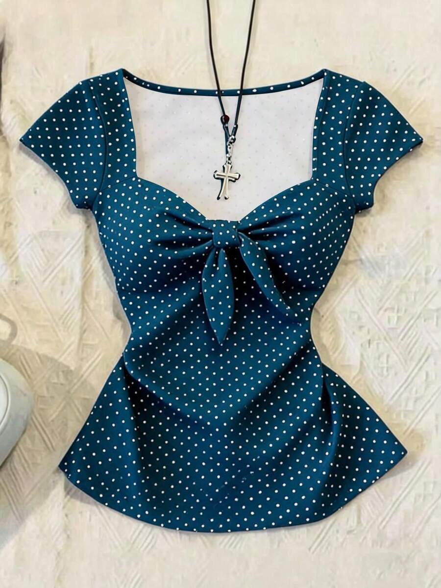 Women's polka dot short sleeve raglan t-shirt with a twist front detail and contrast collar.