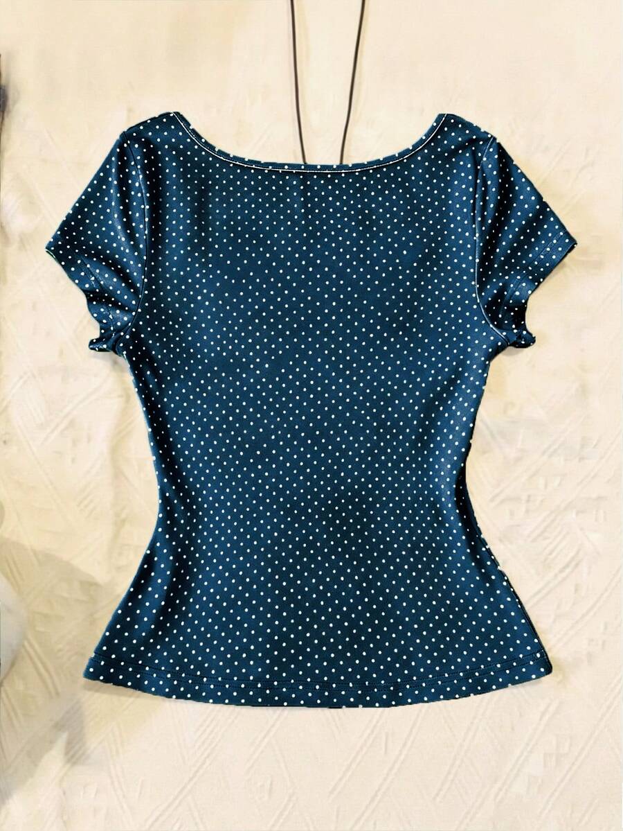 Women's polka dot short sleeve raglan t-shirt with a twist front detail and contrast collar.