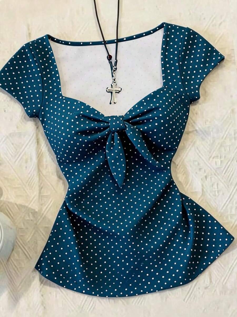 Women's polka dot short sleeve raglan t-shirt with a twist front detail and contrast collar.