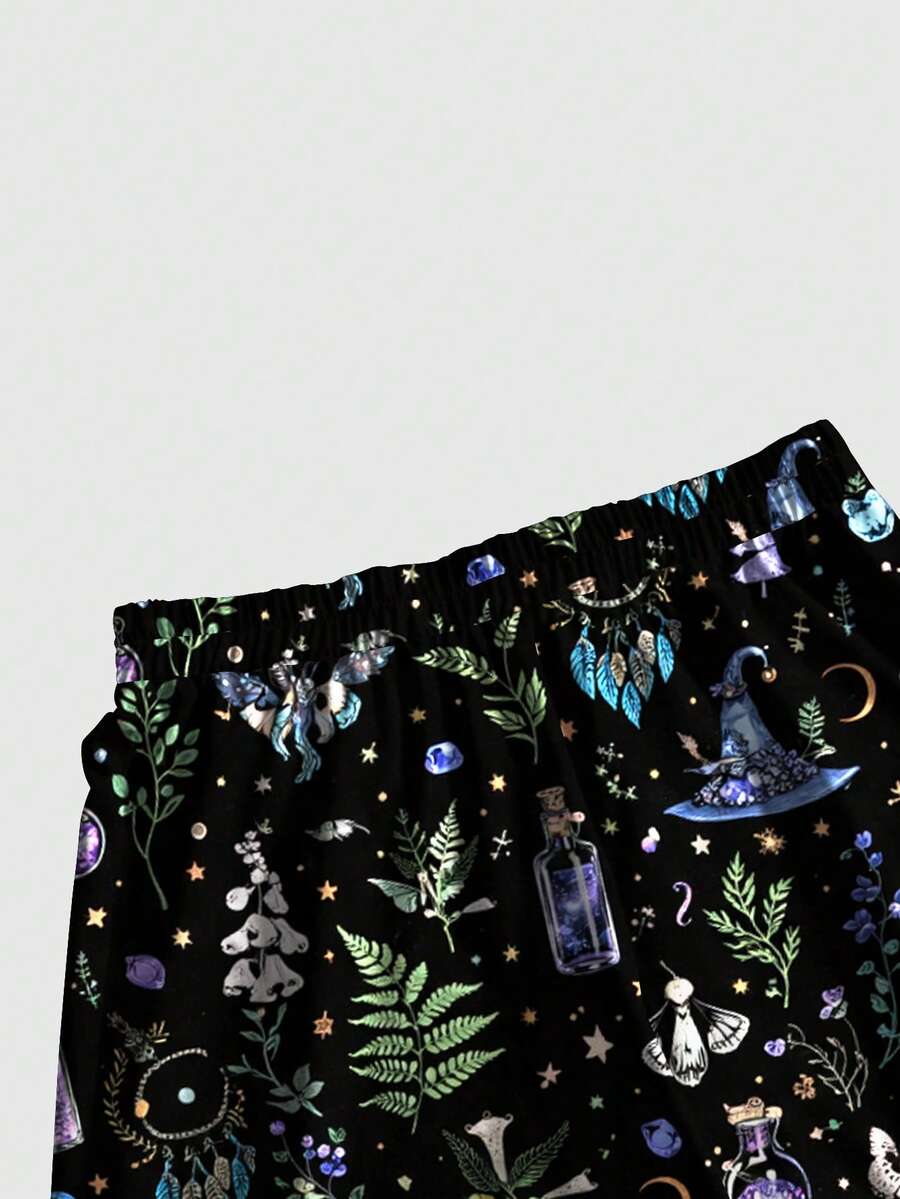 Women's plus size black gothic wide leg pants with split thigh detail and celestial moth, sun, and star pattern.