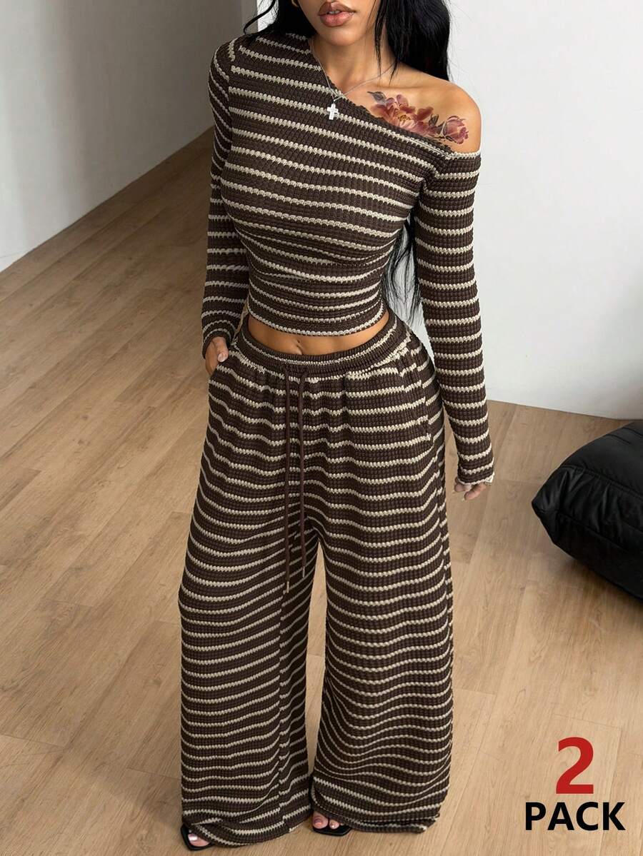 Women's two-piece striped knit tracksuit set featuring a brown asymmetrical neckline long sleeve crop top and matching high-waisted wide leg sweatpants.