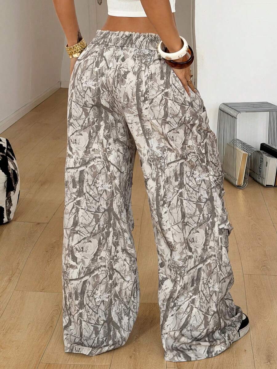Women's black and white striped wide leg pants featuring an elastic drawstring waistband, side pockets, and a loose straight leg fit.