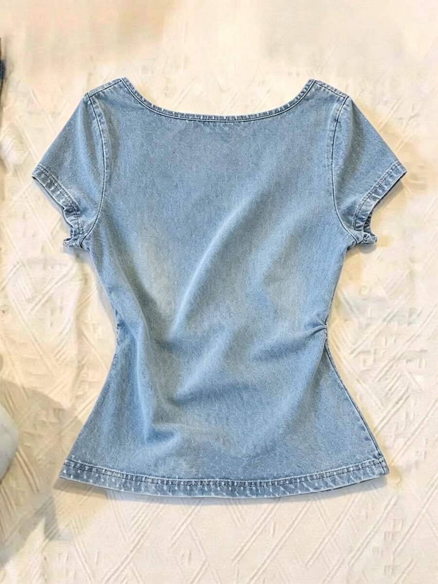 Women's polka dot short sleeve raglan t-shirt with a twist front detail and contrast collar.
