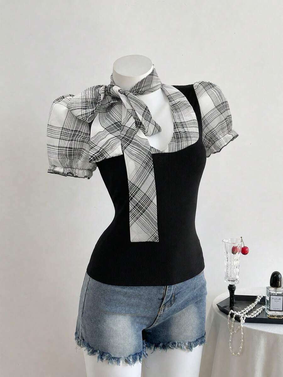 Women's slim fit short sleeve t-shirt featuring puff sleeves, Queen Anne neckline, tie-up front knot, frill detail, and raw hem.