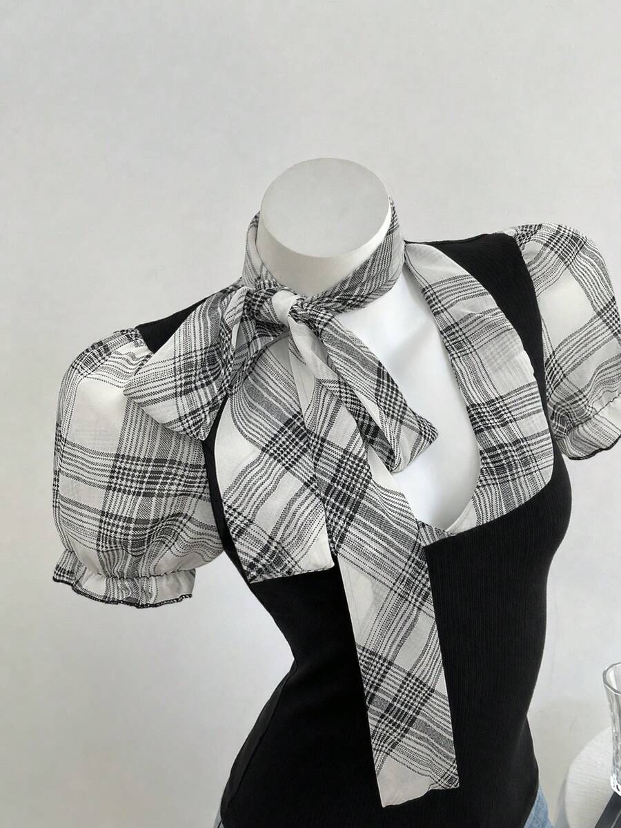 Women's slim fit short sleeve t-shirt featuring puff sleeves, Queen Anne neckline, tie-up front knot, frill detail, and raw hem.