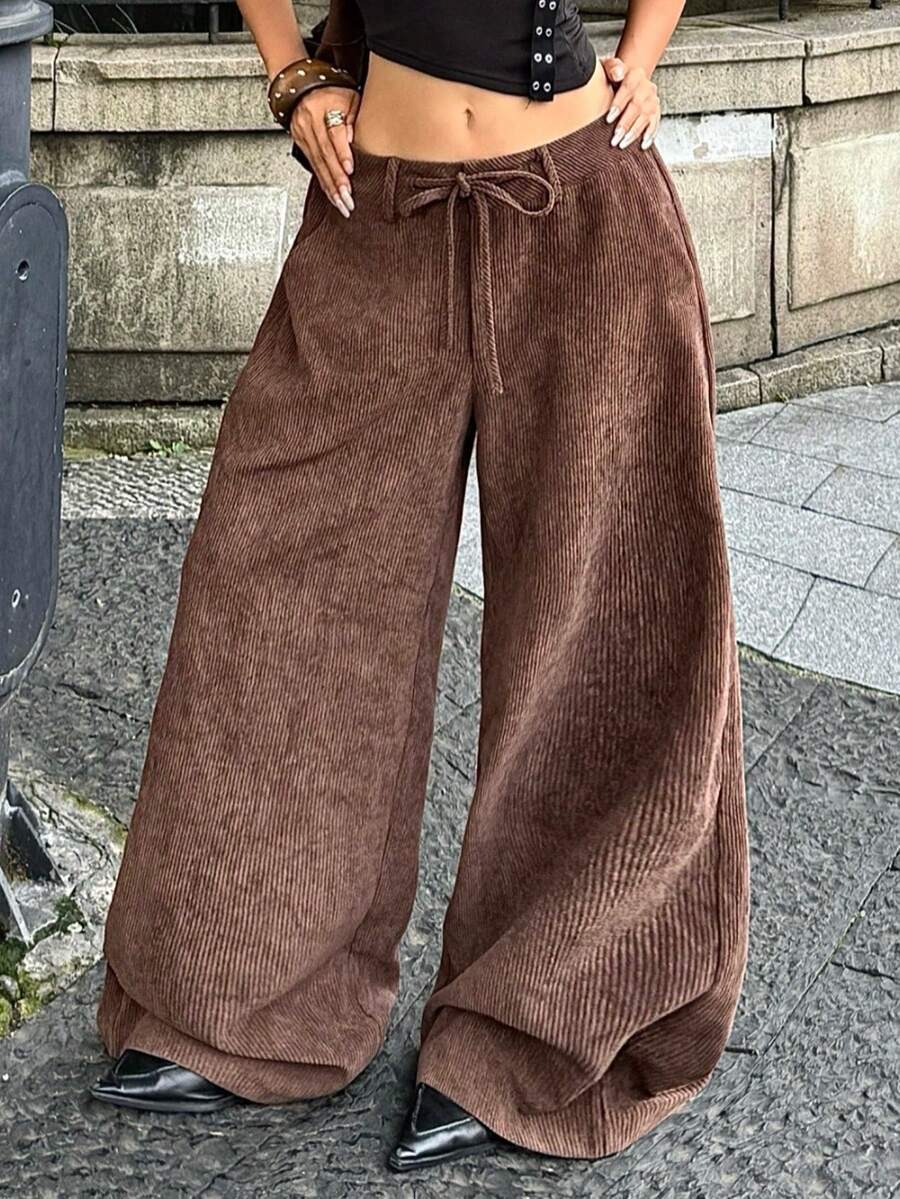 Women's casual straight leg striped woven pants featuring a low waist and zipper fly closure.