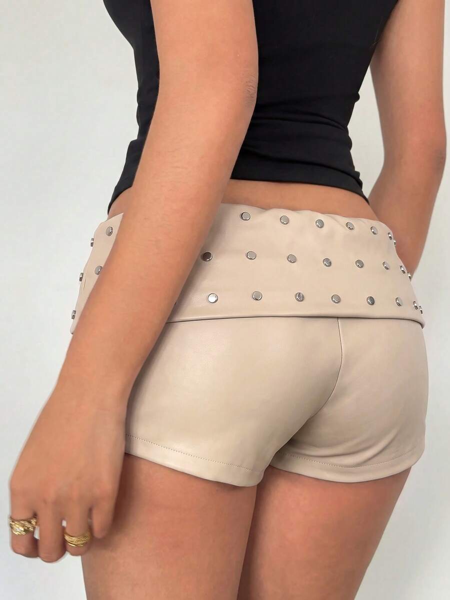Women's studded PU ultra low waist mini shorts with zipper fly closure, skinny fit, mini length, and plain unlined design.
