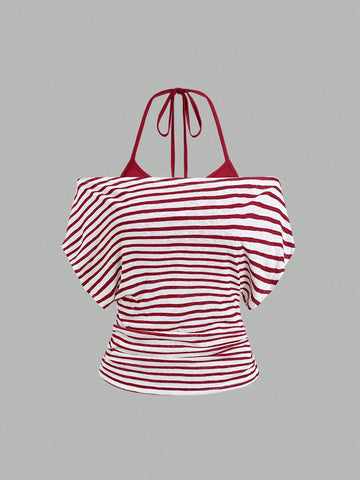 Women's striped tank top featuring an asymmetrical cold shoulder neckline and semi-sheer back.
