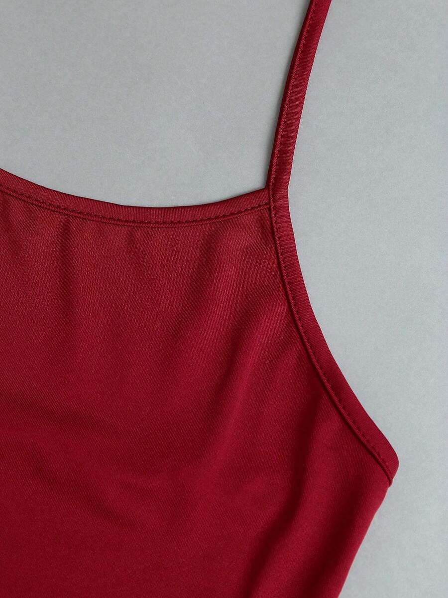 Women's striped tank top featuring an asymmetrical cold shoulder neckline and semi-sheer back.