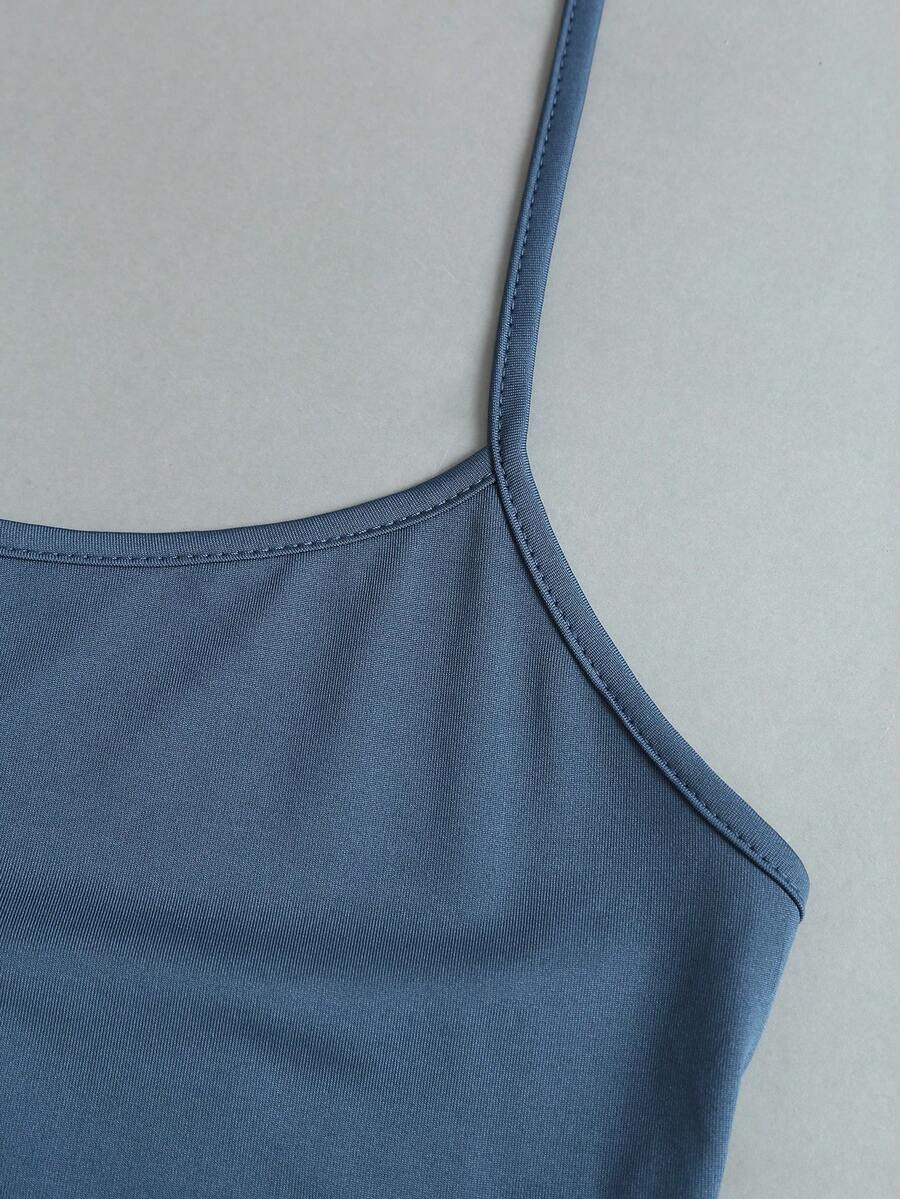 Women's striped tank top featuring an asymmetrical cold shoulder neckline and semi-sheer back.