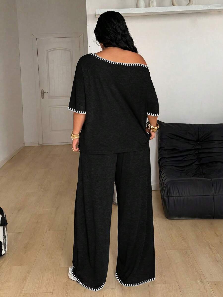 Women's two-piece lounge set featuring a loose drop shoulder asymmetrical neck short sleeve t-shirt and wide-leg knit pants with pockets.