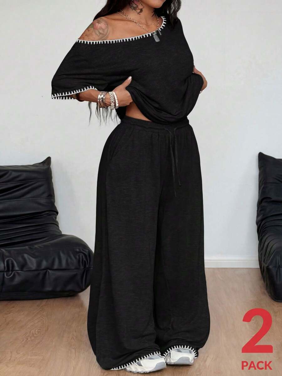 Women's two-piece lounge set featuring a loose drop shoulder asymmetrical neck short sleeve t-shirt and wide-leg knit pants with pockets.