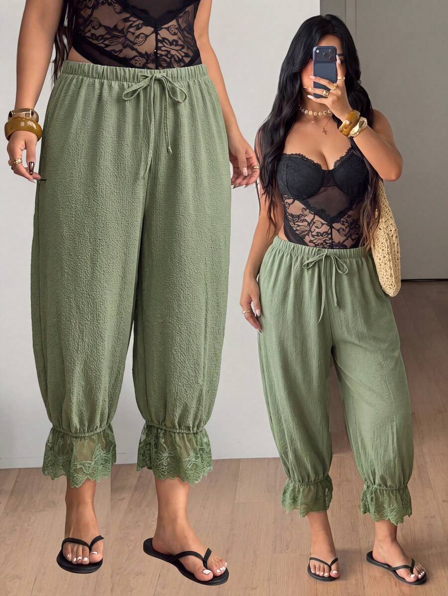 Women's loose-fitting lantern bloomer pants in capri length featuring delicate contrast lace trim and a drawstring waist.