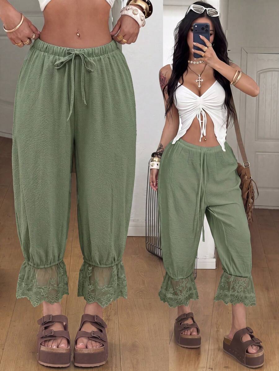 Women's loose-fitting lantern bloomer pants in capri length featuring delicate contrast lace trim and a drawstring waist.