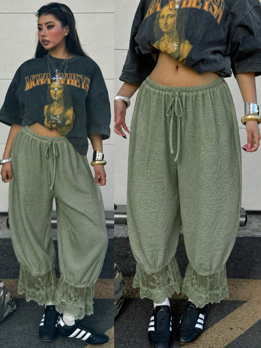 Women's loose-fitting lantern bloomer pants in capri length featuring delicate contrast lace trim and a drawstring waist.