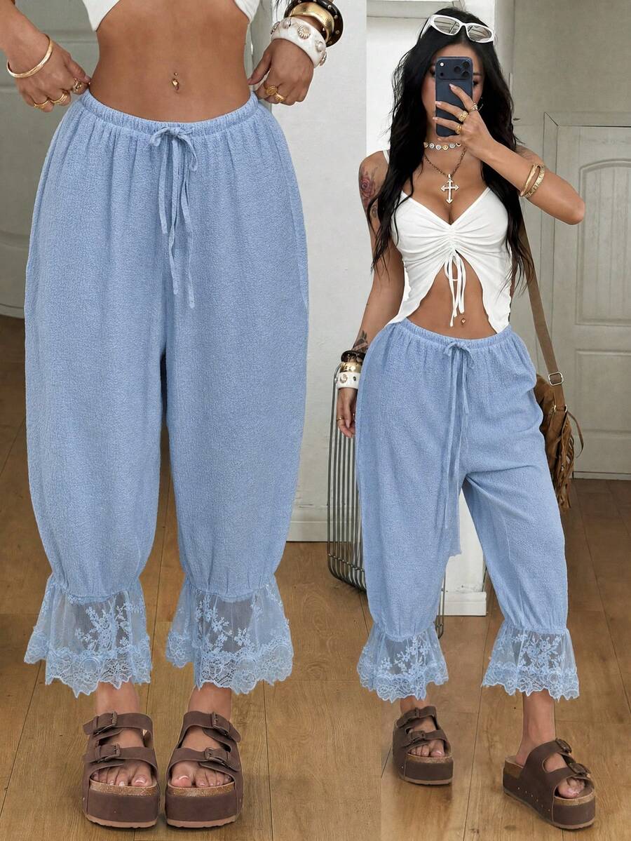 Women's loose-fitting lantern bloomer pants in capri length featuring delicate contrast lace trim and a drawstring waist.