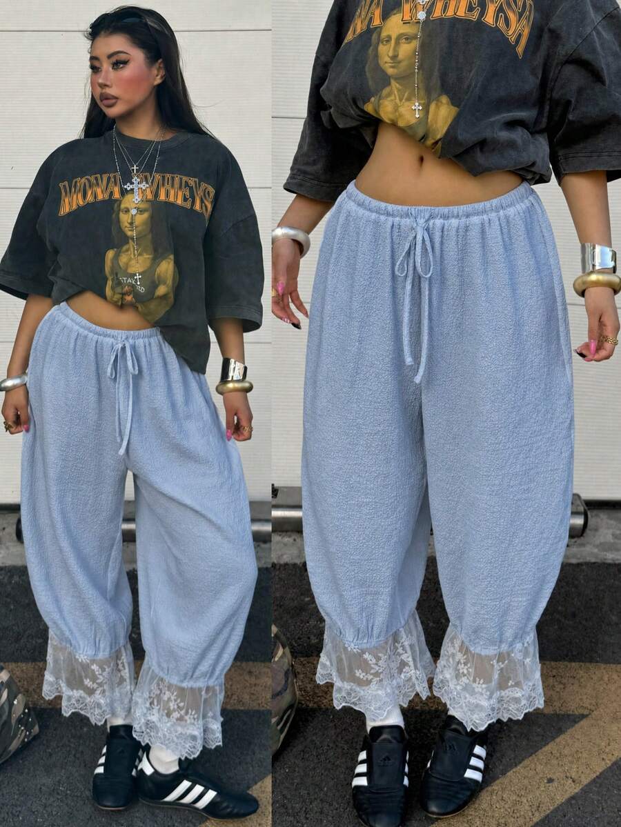 Women's loose-fitting lantern bloomer pants in capri length featuring delicate contrast lace trim and a drawstring waist.