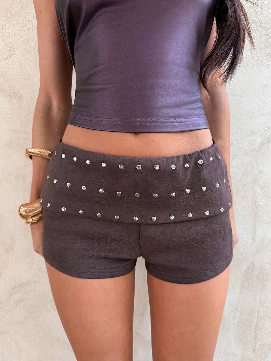 Women's studded PU ultra low waist mini shorts with zipper fly closure, skinny fit, mini length, and plain unlined design.