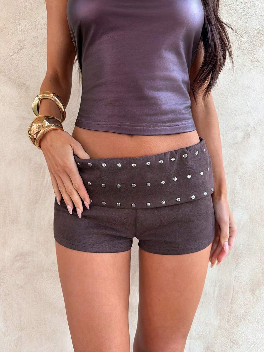 Women's studded PU ultra low waist mini shorts with zipper fly closure, skinny fit, mini length, and plain unlined design.
