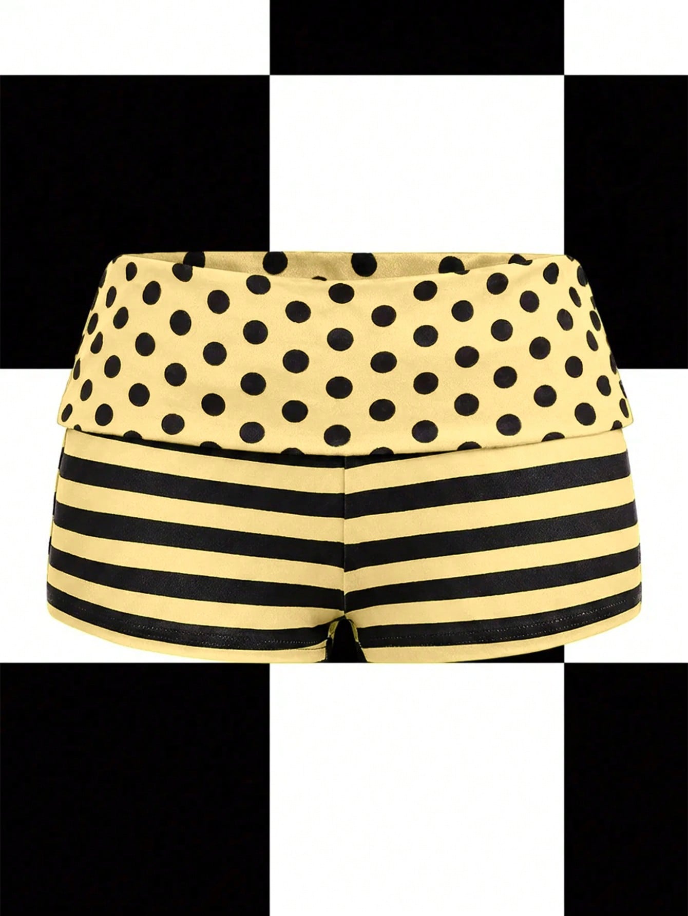 Women's black low waist mini track shorts with contrast polka dot, striped, geometric, and plant-inspired print details, elastic waistband, and skinny fit