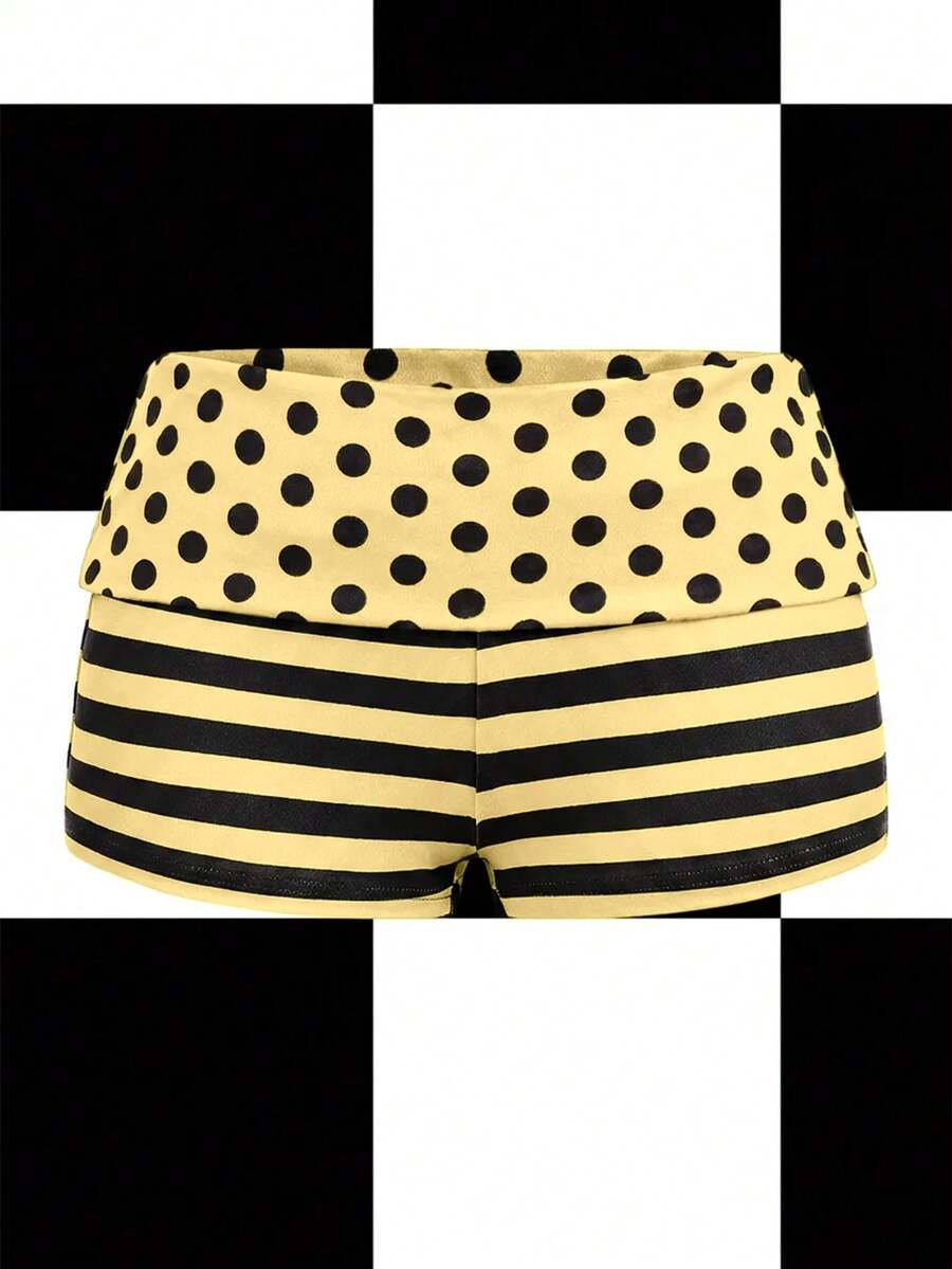 Women's black low waist mini track shorts with contrast polka dot, striped, geometric, and plant-inspired print details, elastic waistband, and skinny fit