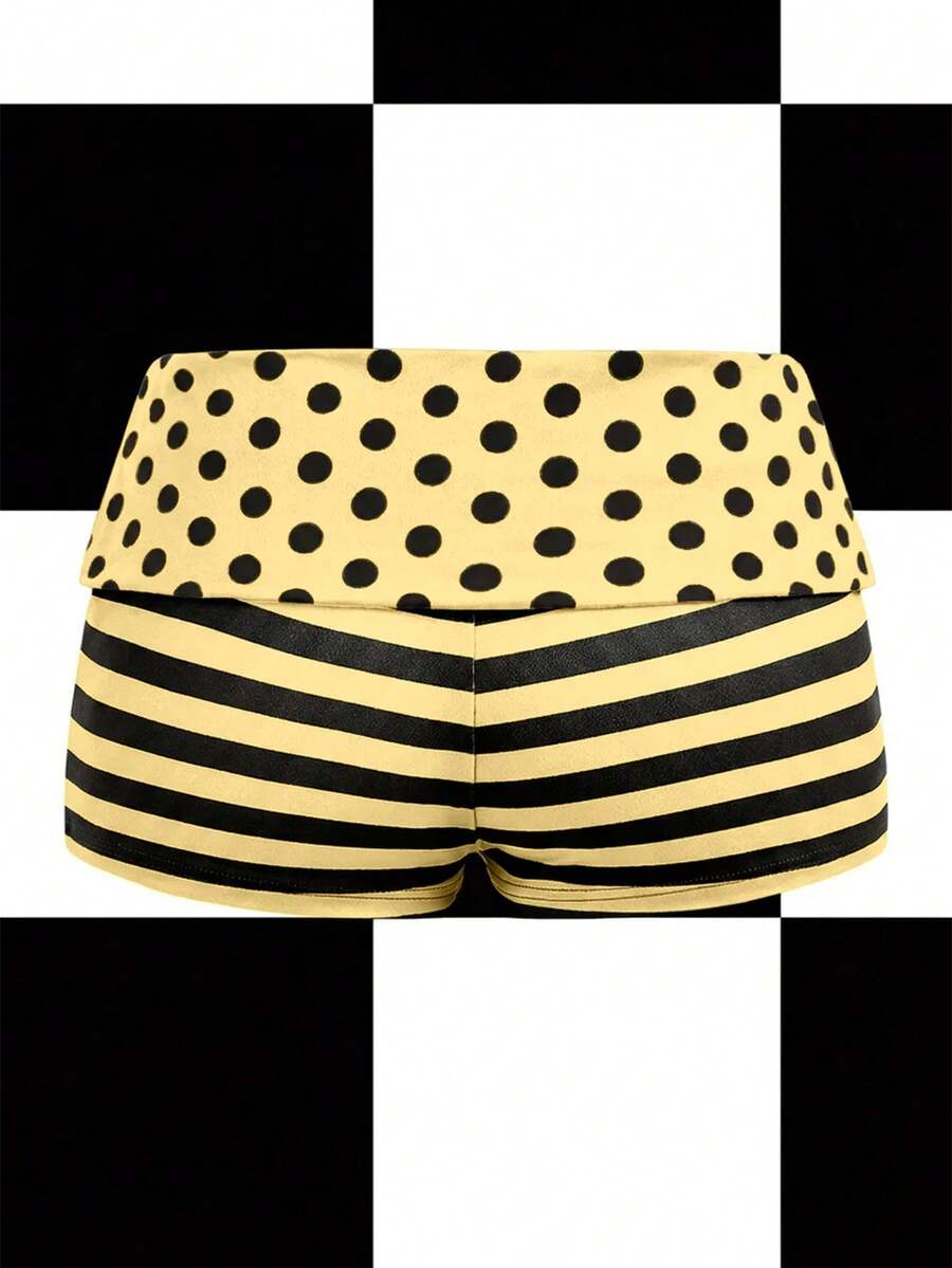 Women's black low waist mini track shorts with contrast polka dot, striped, geometric, and plant-inspired print details, elastic waistband, and skinny fit