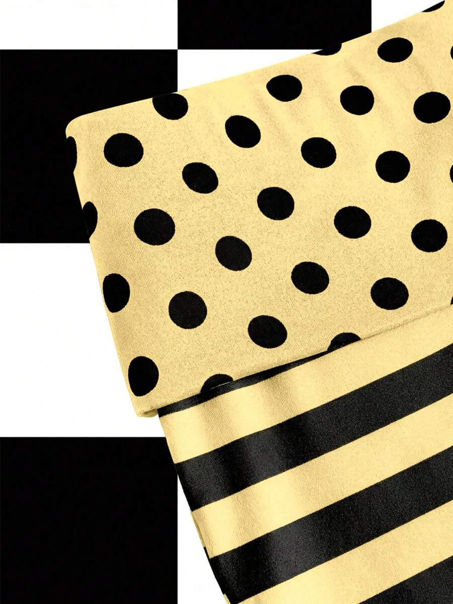 Women's black low waist mini track shorts with contrast polka dot, striped, geometric, and plant-inspired print details, elastic waistband, and skinny fit