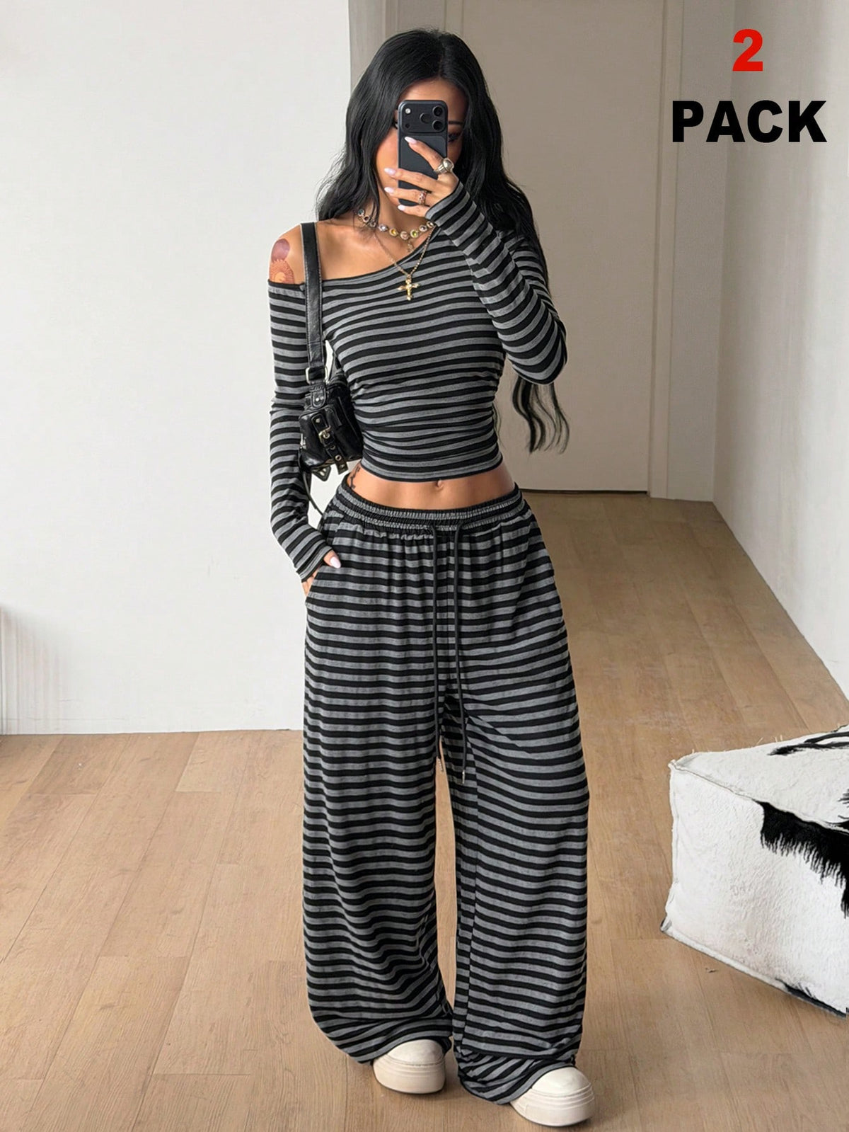 Women's two-piece striped knit tracksuit set featuring a brown asymmetrical neckline long sleeve crop top and matching high-waisted wide leg sweatpants.
