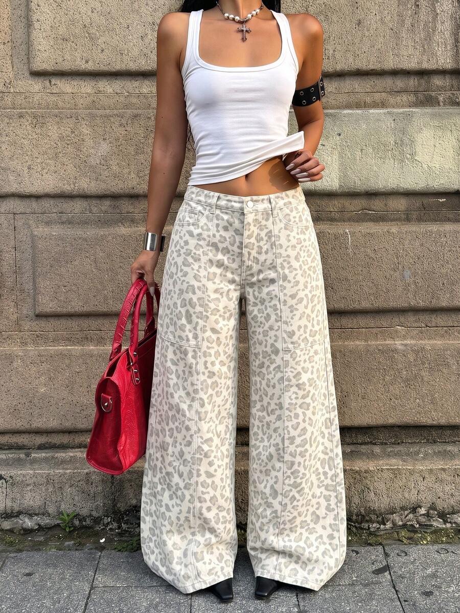 Front view of women's loose wide leg denim jeans featuring a mid waist, classic front pockets, and a zipper fly closure.