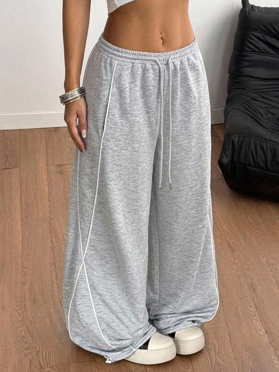 Women's wide leg trousers with a tree branch graphic pattern, loose fit, and mid-rise waist in woven fabric.