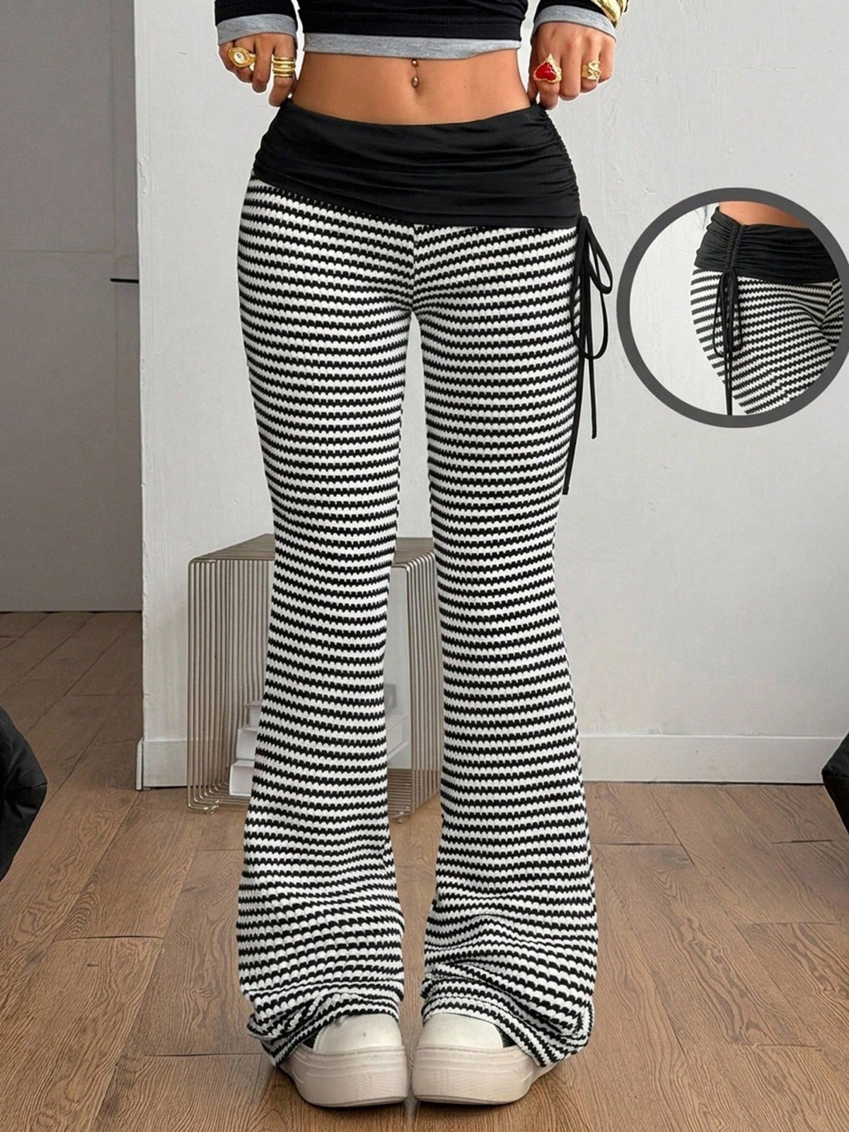 Women's black and white polka dot flare leg pants with side drawstring and ruched details