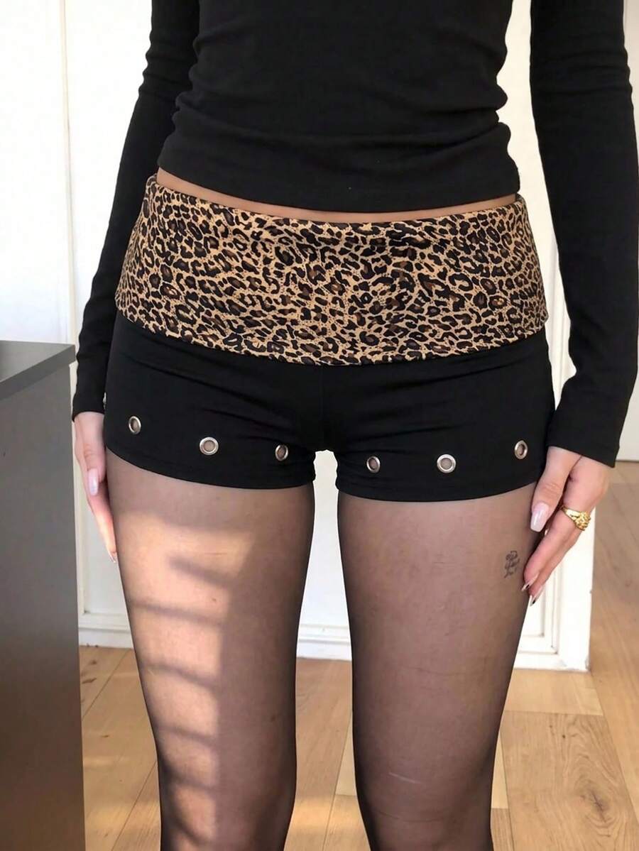 Women's studded PU ultra low waist mini shorts with zipper fly closure, skinny fit, mini length, and plain unlined design.