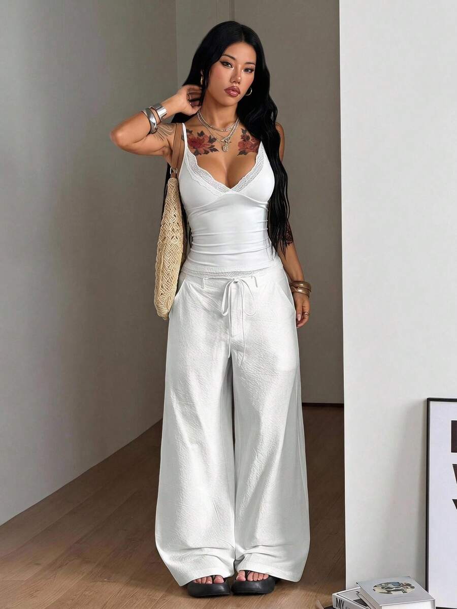Women's casual straight leg striped woven pants featuring a low waist and zipper fly closure.