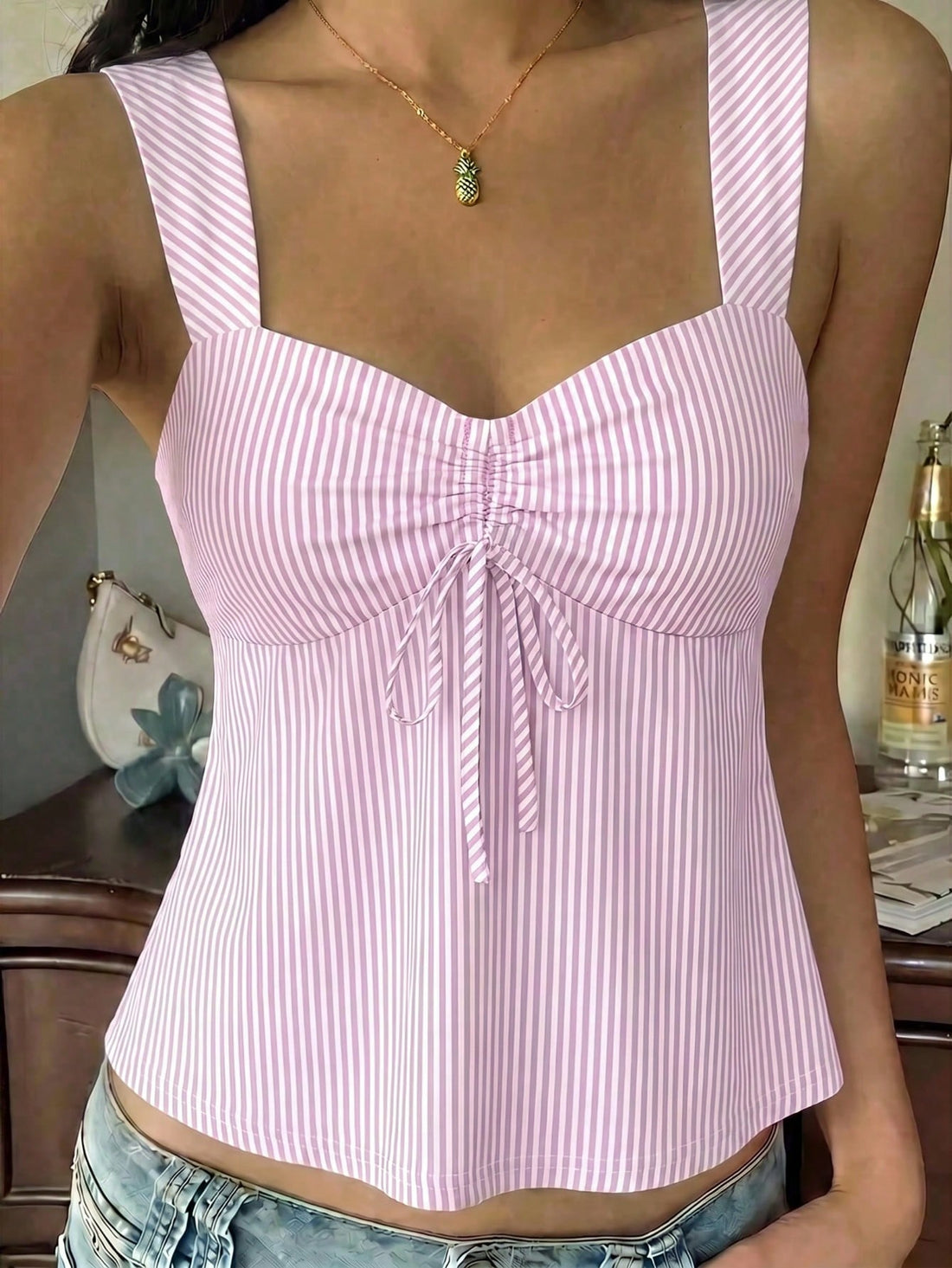 Women's striped camisole tank top with strap neckline, backless knot detail, cold shoulder styling, slim fit, and flared hem for casual vacation or daily wear.