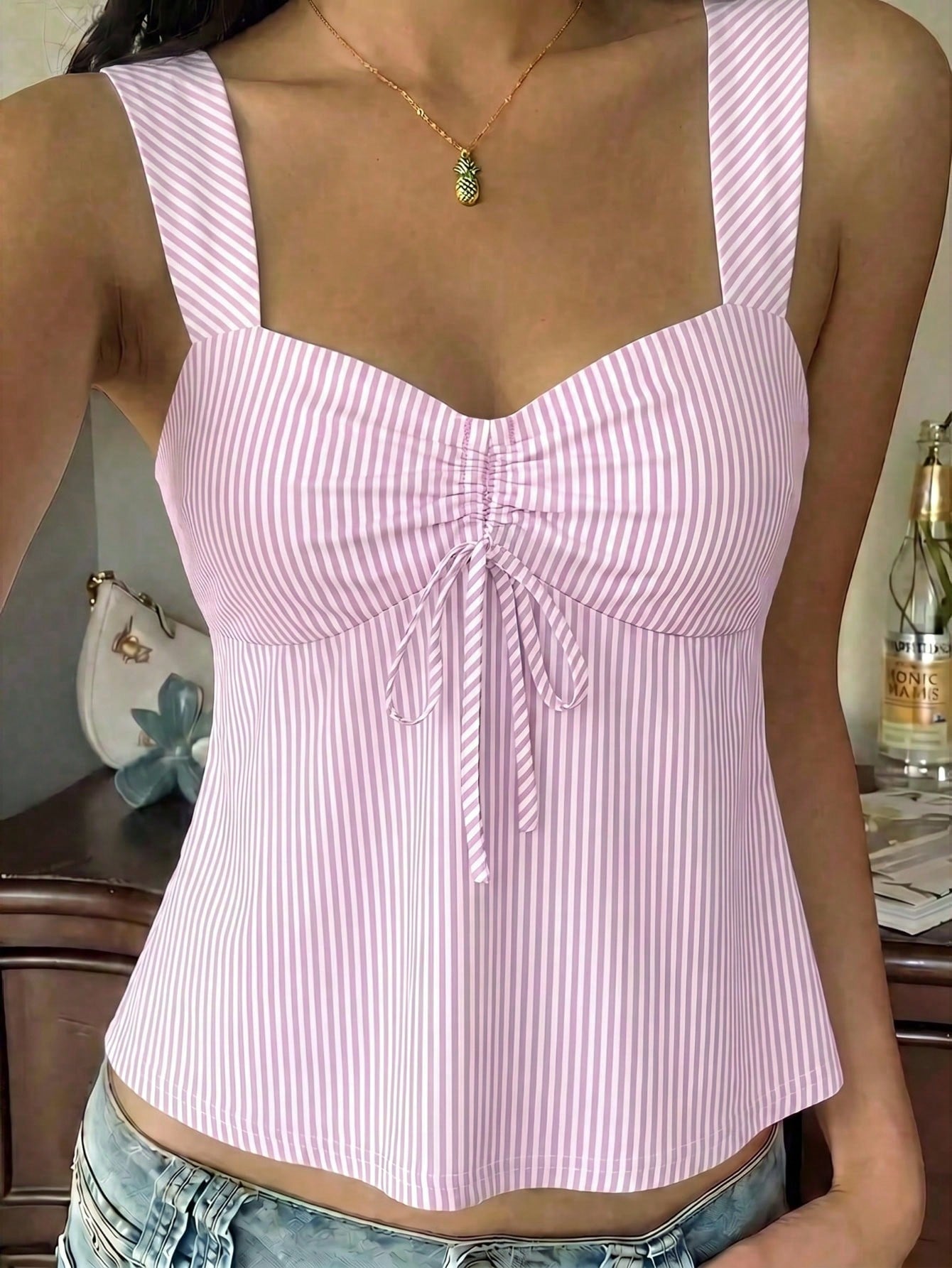 Women's striped camisole tank top with strap neckline, backless knot detail, cold shoulder styling, slim fit, and flared hem for casual vacation or daily wear.