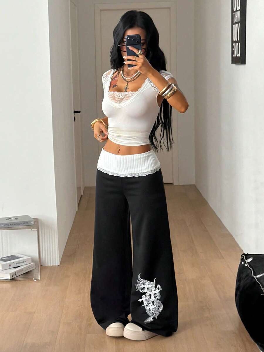 Women's wide leg flare sweatpants featuring a black and white colorblock contrast fold waistband and side stripe details.