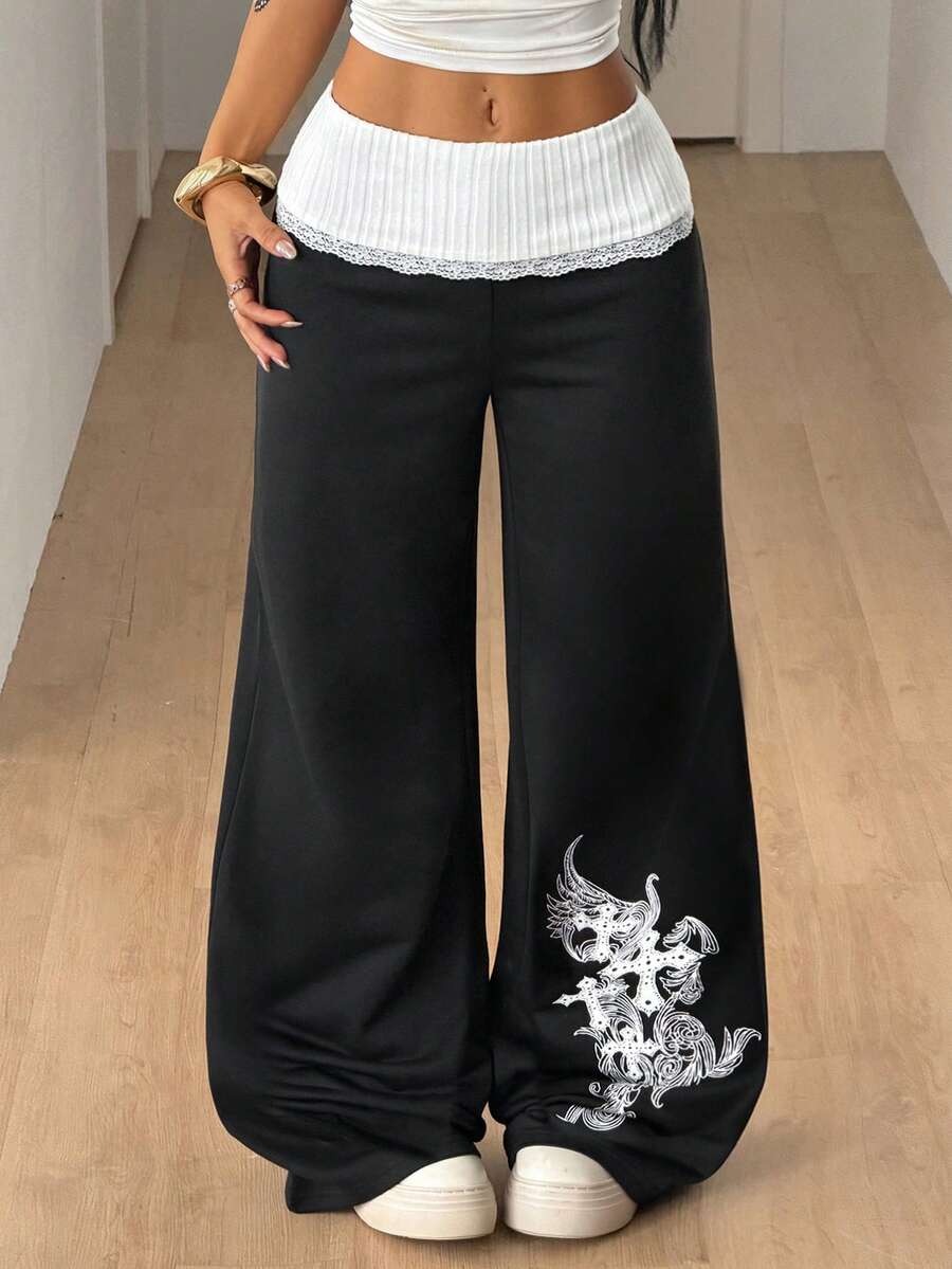 Women's wide leg flare sweatpants featuring a black and white colorblock contrast fold waistband and side stripe details.