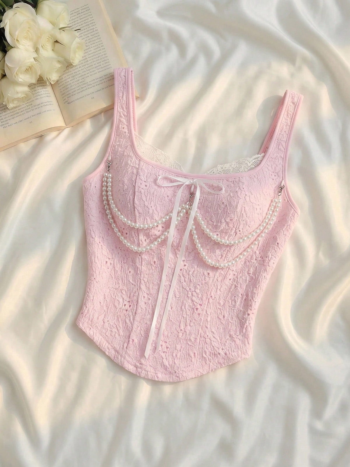 women's black wide-strap tank top featuring a lace collar, detachable bow chain decor with pearl details, and an asymmetrical hem.