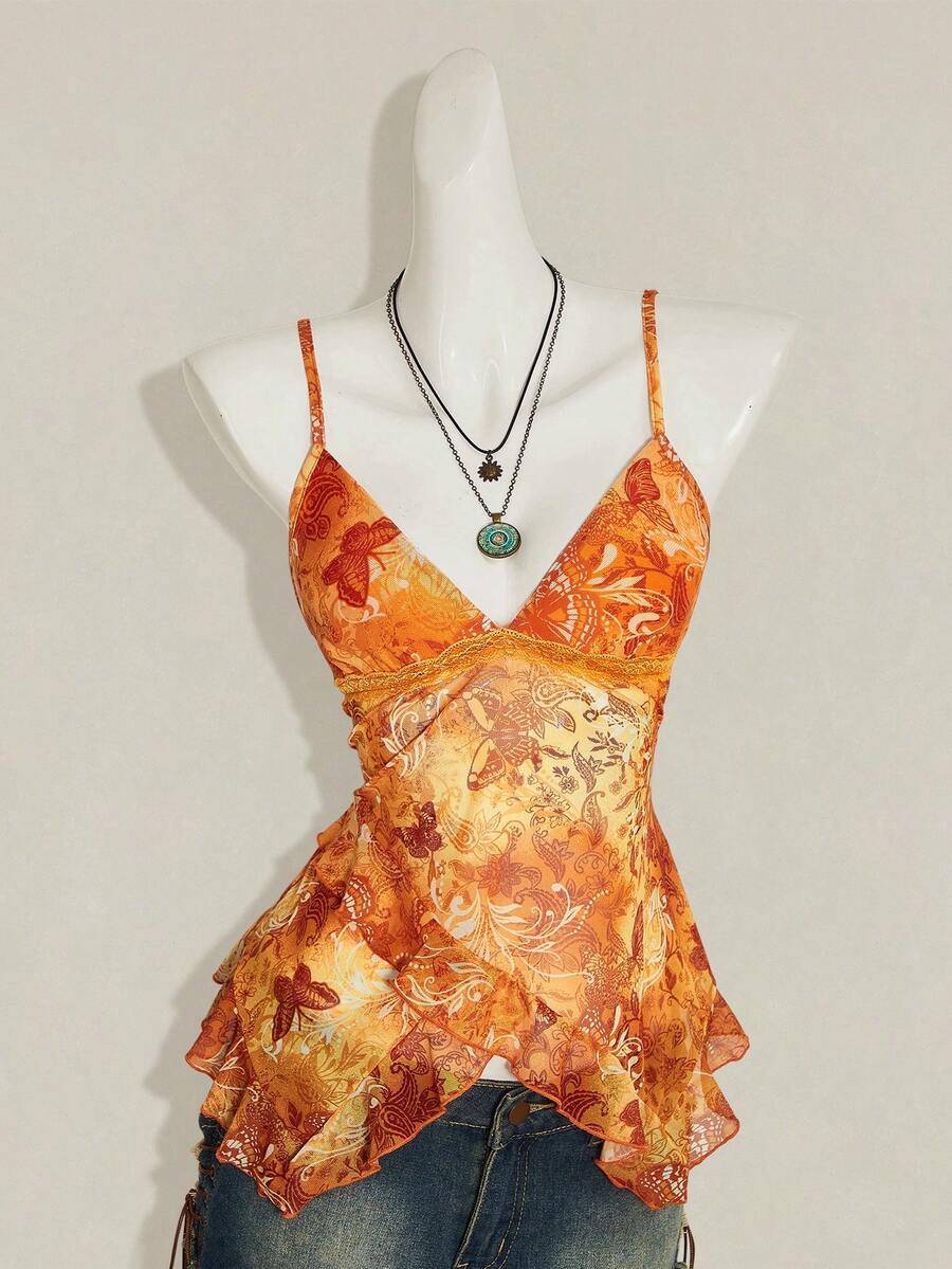Women's graphic print camisole top featuring thin spaghetti straps, a backless cut, and an asymmetrical hem.