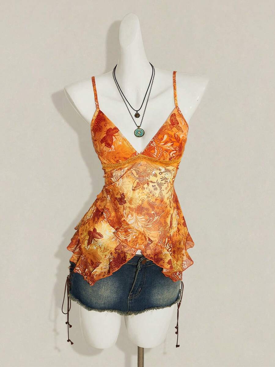 Women's graphic print camisole top featuring thin spaghetti straps, a backless cut, and an asymmetrical hem.