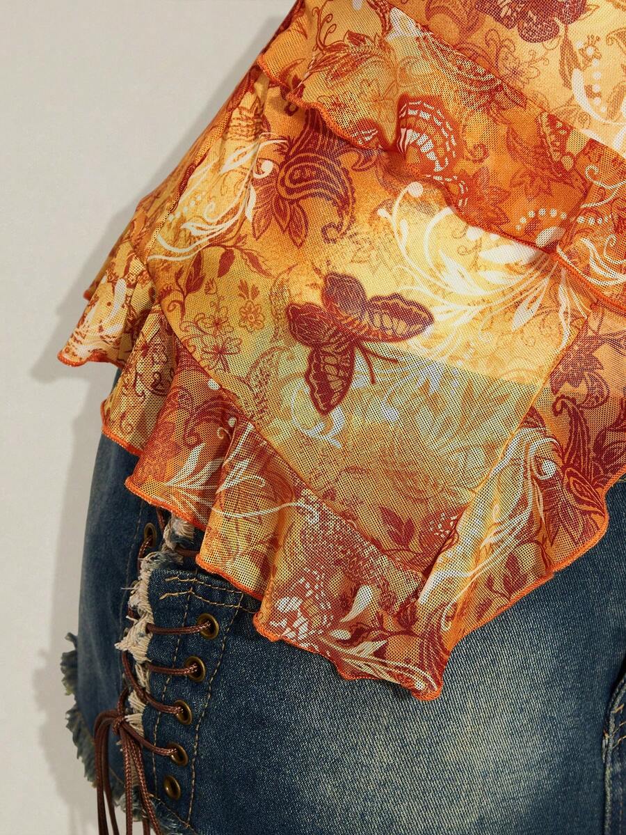Women's graphic print camisole top featuring thin spaghetti straps, a backless cut, and an asymmetrical hem.