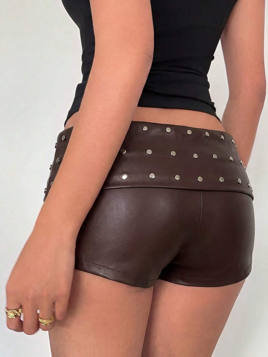 Women's studded PU ultra low waist mini shorts with zipper fly closure, skinny fit, mini length, and plain unlined design.